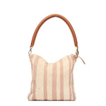Artisan hand woven Florentina clutch-to-hobo bag in snow pattern. The front of the Florentina is fully unfolded with a leather handle and vertical pale pink and beige stripes.