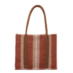 Hand woven artisan Irma Tote in Chestnut pattern. The back is shown with a vertical stripe pattern of burgundy, and tan stripes. It has brown handles.