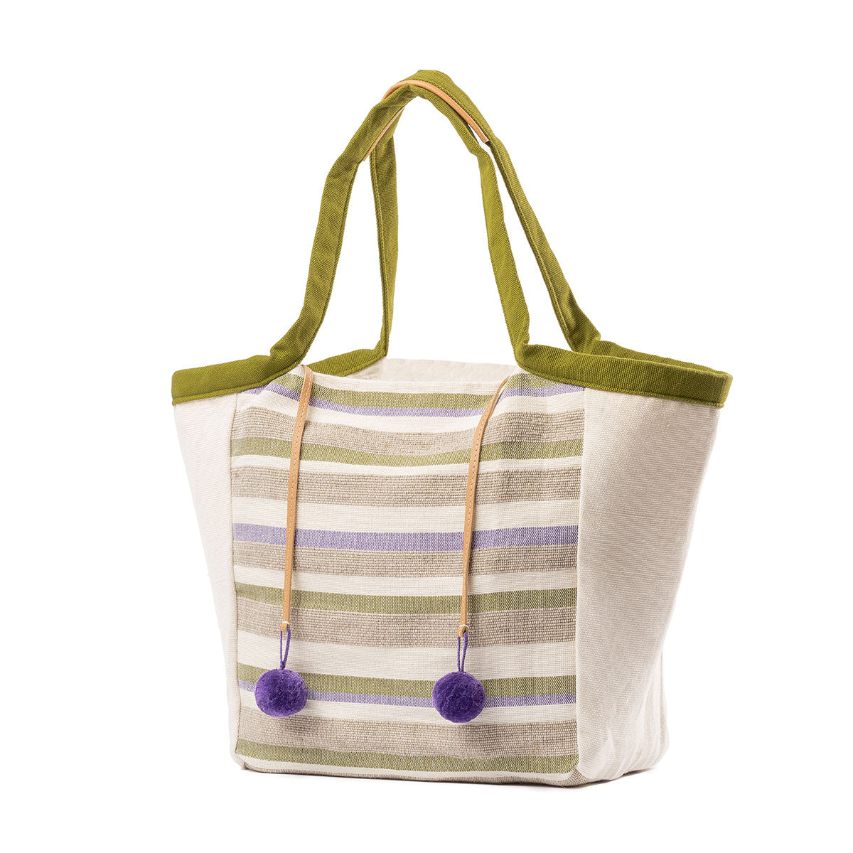 An angle view of the hand woven artisan Rosa Tote in Woodland Stripes.The center has a pastel green, purple, and beige horizontal stripe pattern. The sides have beige fabric. It has moss green handles with leather detailing. It has two purple pompoms attached to leather cords.