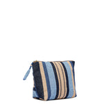 Left-sided angle view of the Front view of the Mini Cristina Pouch in Skyscape. The front pattern has vertical navy, beige, and light blue stripes. The zipper has a woven blue tassel.