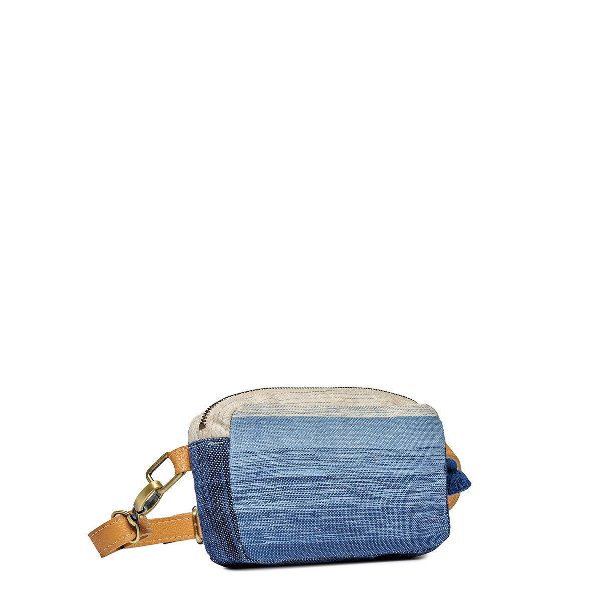 A left-sided angle view of the Felipa Belt Bag in Ocean Breeze. It has a white to dark blue gradient pattern with dark blue sides. It has an adjustable leather strap with clasp, leather zipper pull, and mini blue tassel.