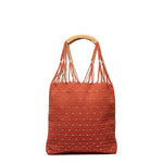 Front view of the Apolonia Tote in Desert Sands. The pattern is coral pink with horizontal beige dots. It has thread wrapped cord handles.