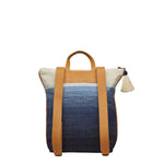 Back of the Lorena Backpack in Ocean Breeze. It has a white to dark blue gradient pattern. It has adjustable leather straps and a cotton tassel.