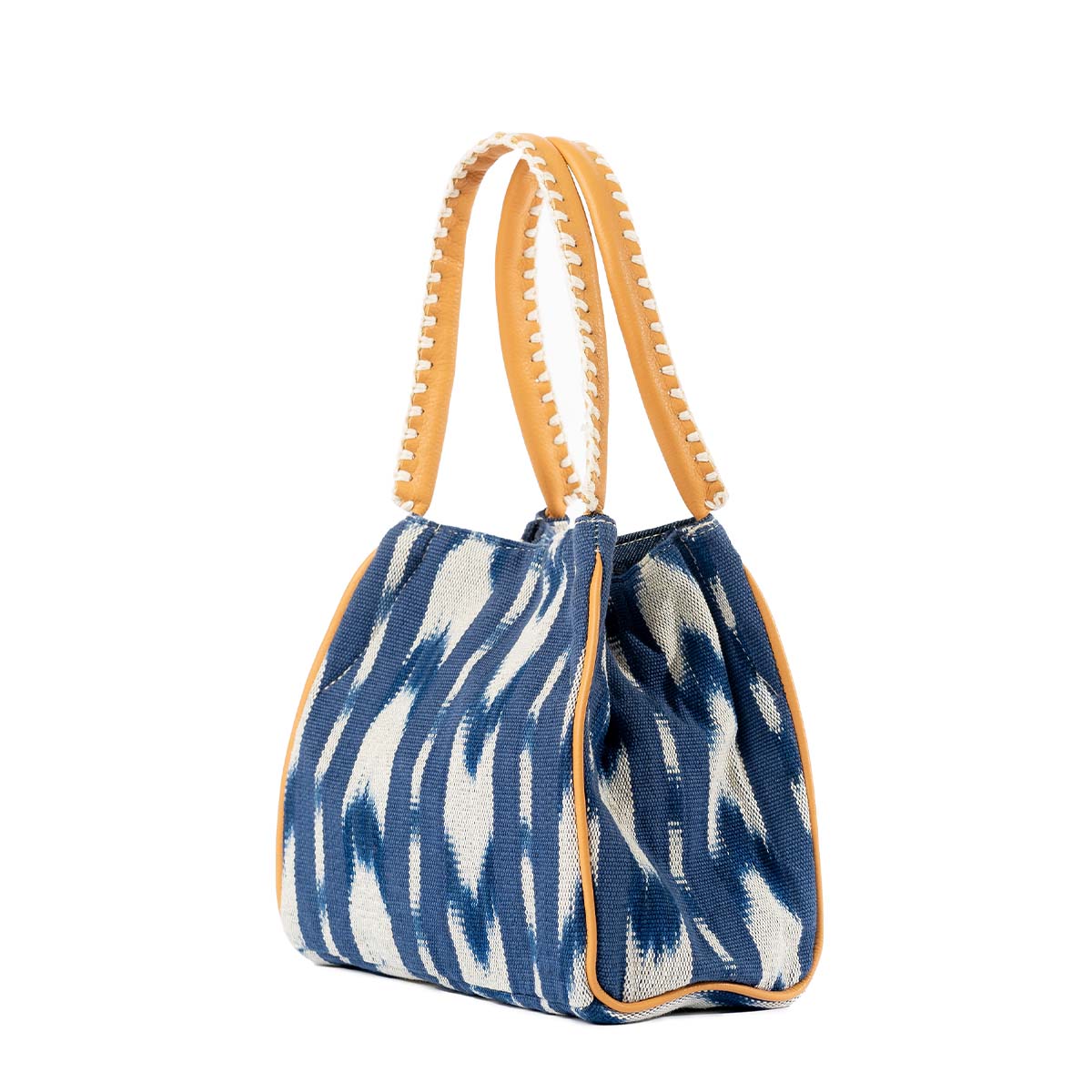 A right-sided angle of the hand woven artisan Flora Petite Crossbody in Atitlán Hills pattern. It has vertical and chevron dark blue and white stripes.