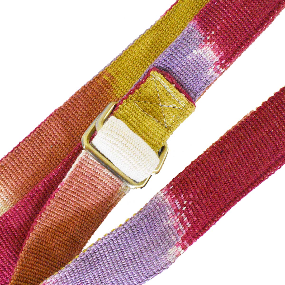 A zoomed-in detail of the Celeste Belt in Raspberry Paleta pattern, with a focus on the buckle. It has a flame stitch red, purple, yellow ochre, and white pattern.