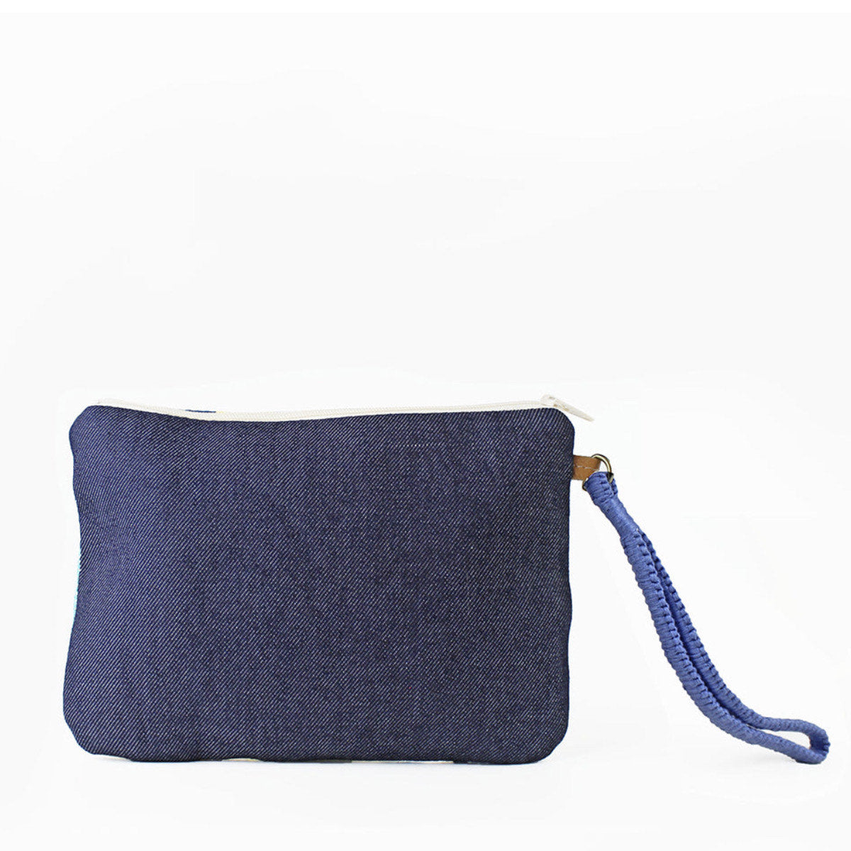 Back of the hand woven artisan Mini Lily Wristlet Clutch in Denim Pacific. The back has a dark wash denim fabric. It has a woven blue hand strap.