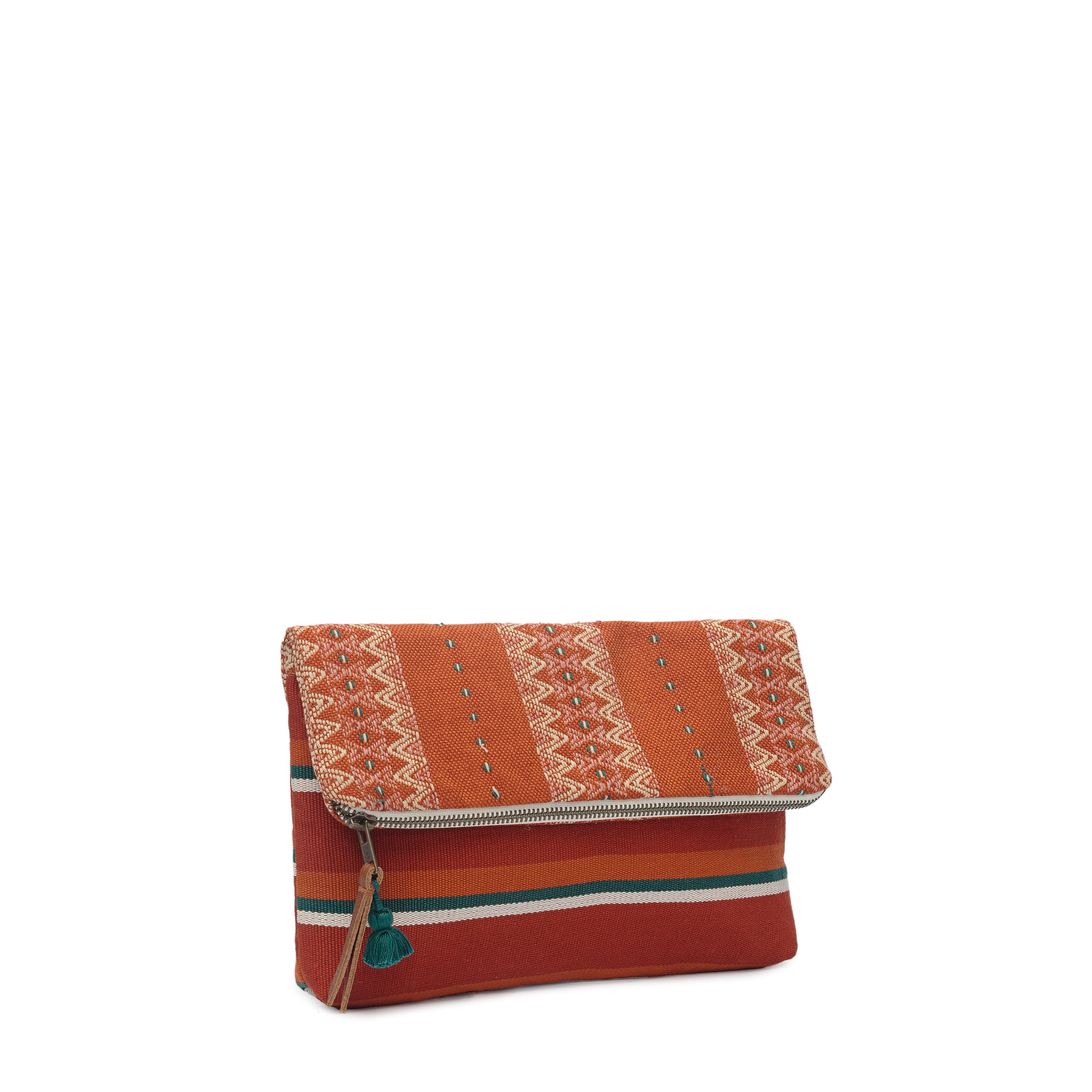 A left sided view of the Celia Clutch in Ginger color. The Clutch has two patterns, one with a red and green vertical striped fabric, and the other with a zigzag yellow and orange pattern. It has a mini green tassel and a leather zipper pull.