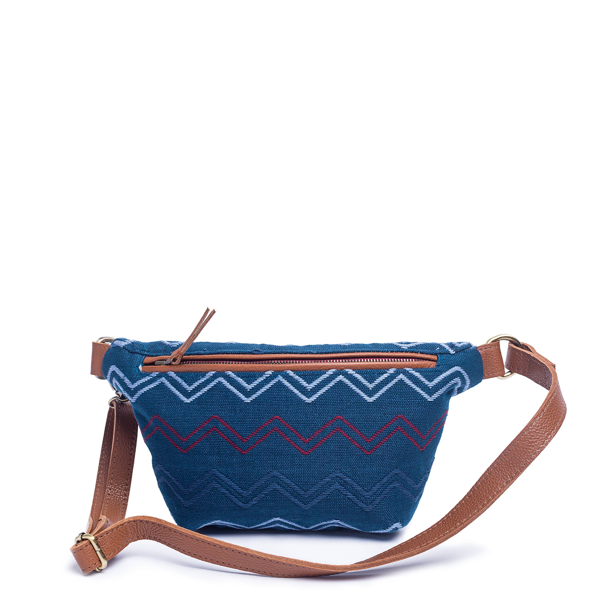 Front of the hand woven artisan Cruza Lake Ripple Sling Belt Bag. The fabric has a horizontal zigzag in light blue, dark blue, and red over a dark blue fabric. It has a leather adjustable strap, leather hem for the zipper, and leather zipper pull.