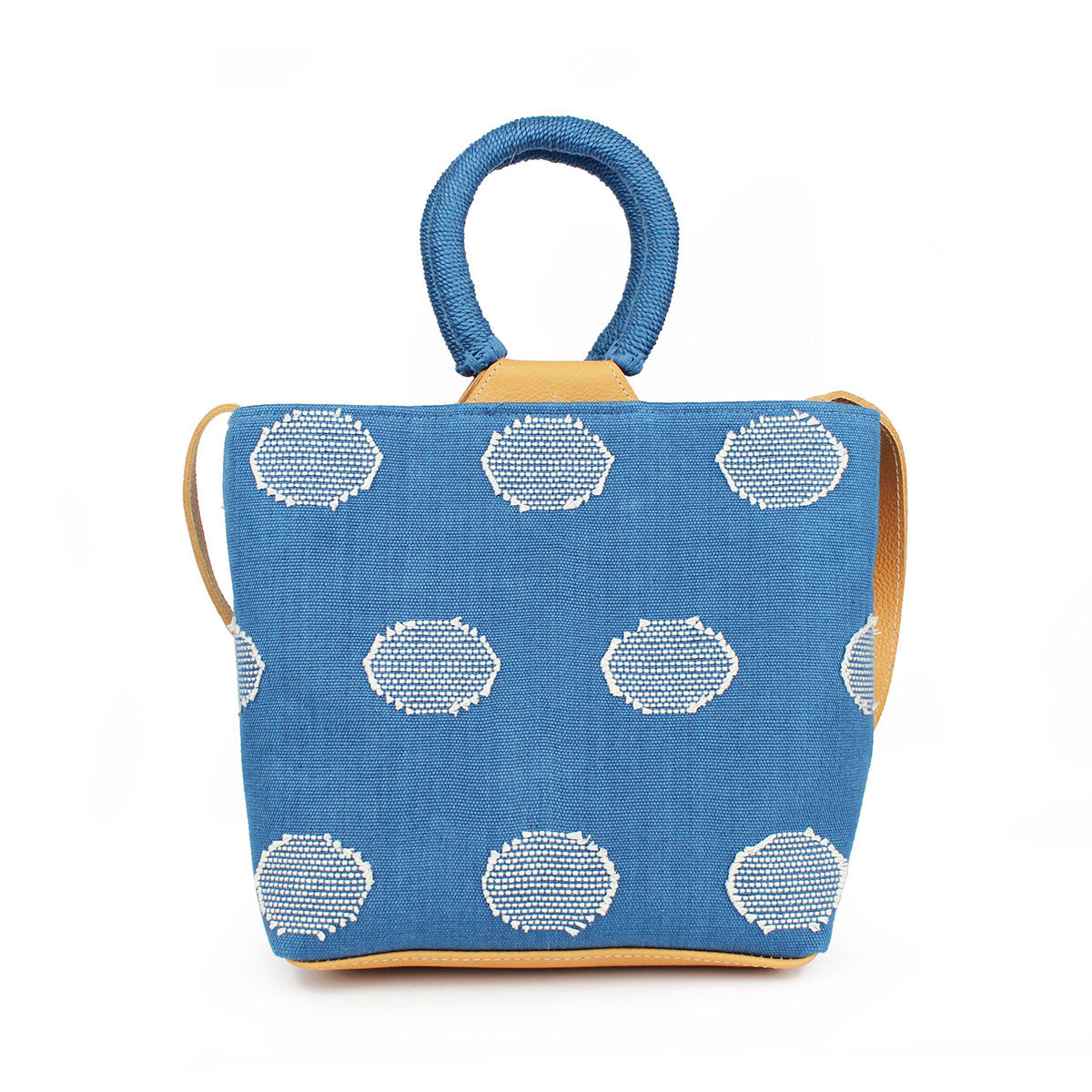 Back of the hand woven artisan Dalila Midi Tote in Ocean Blue. The bag has rounded handles coiled in blue thread. The pattern is the same as the front side, with white circles over a blue background.