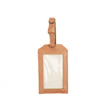 Hand woven artisan Ines Luggage Tag. It has a plastic cover with a leather frame and leather adjustable loop.