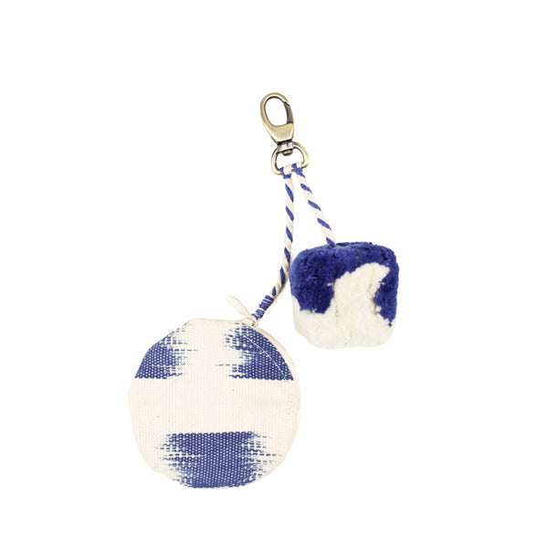 Hand woven artisan All You Need Keychain in Brushstrokes pattern. A mini zip pouch with blue flame stitch and a small blue and white pompom attached to a clasp.