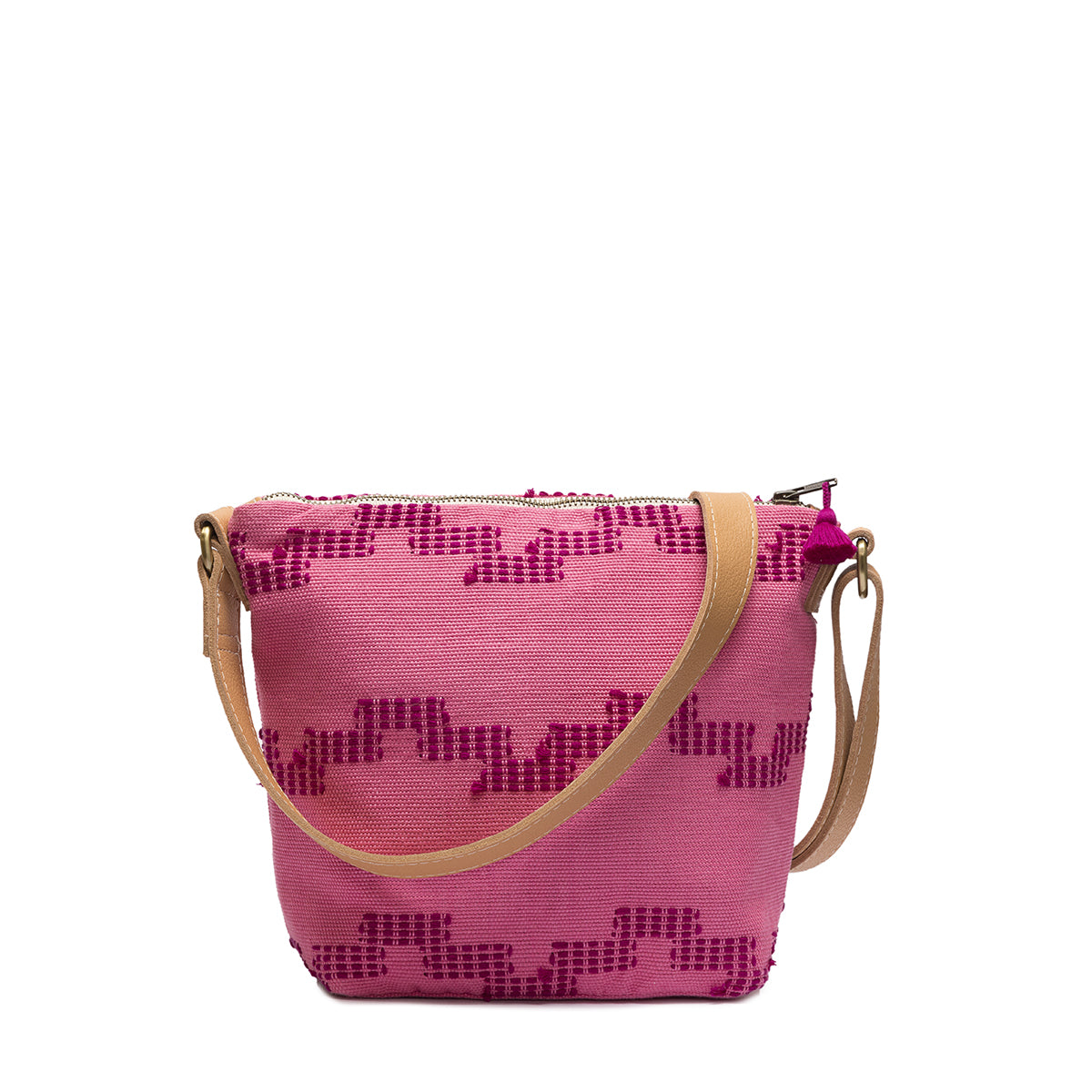 Artisan Mini Lidia Handwoven Crossbody in Pitaya style. The Pitaya pattern has a pink background with geometric wavy stripes. It has a leather crossbody strap and a dark pink tassel detail.