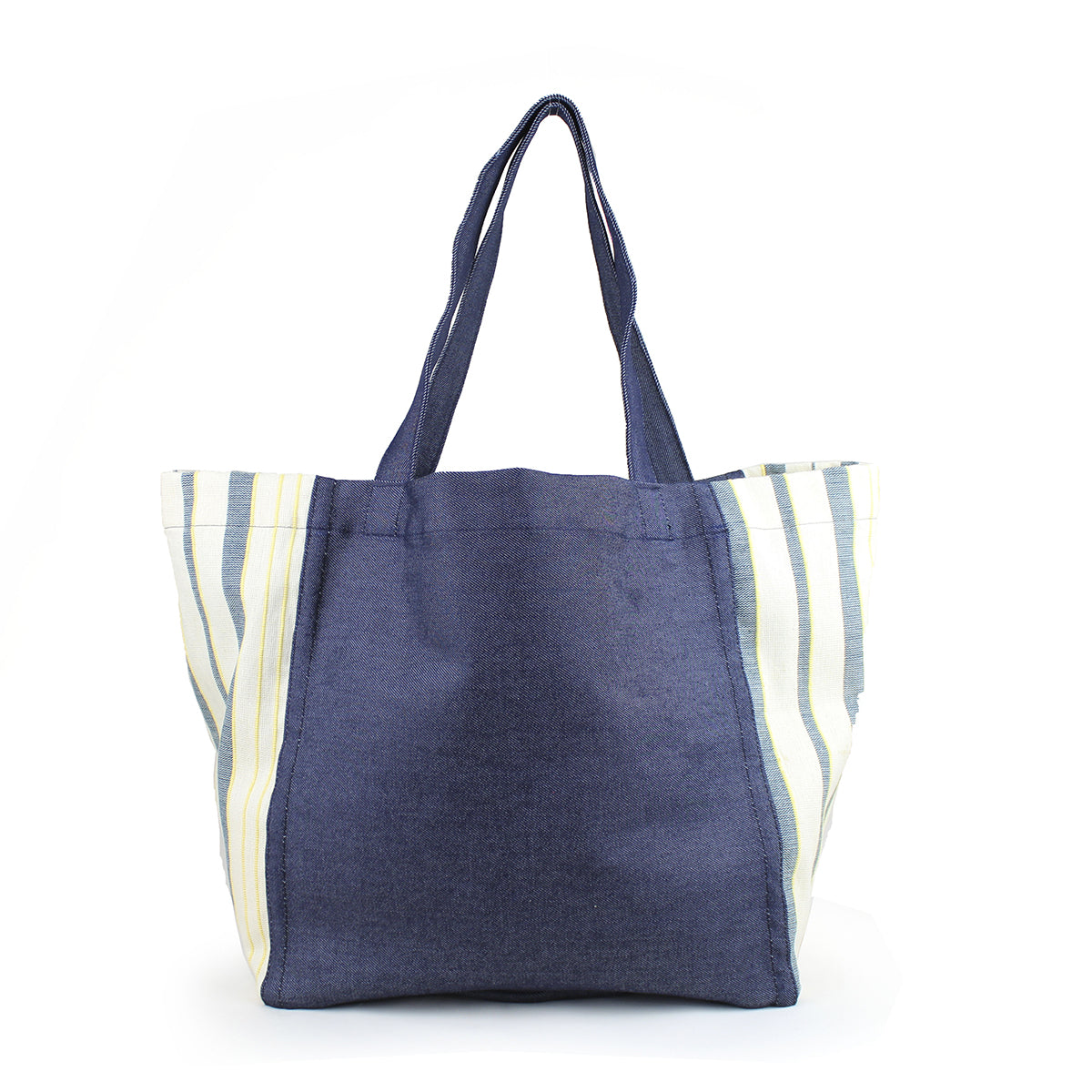 Blanca Handwoven Tote in Denim Ocean pattern. The tote has a dark wash denim. The sides have a light blue, yellow, and white vertical striped fabric.