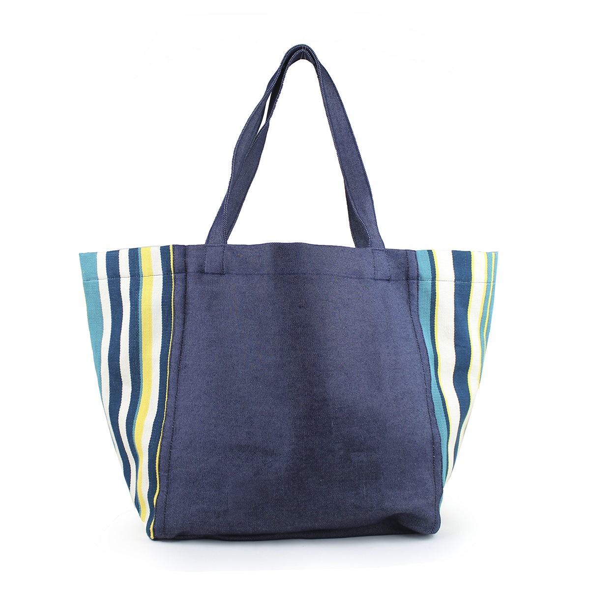 Blanca Handwoven Tote Denim Pacific. The bag has a dark wash denim center and handles. The ends of the bags have a triangle finish in vertical blue and yellow stripes.