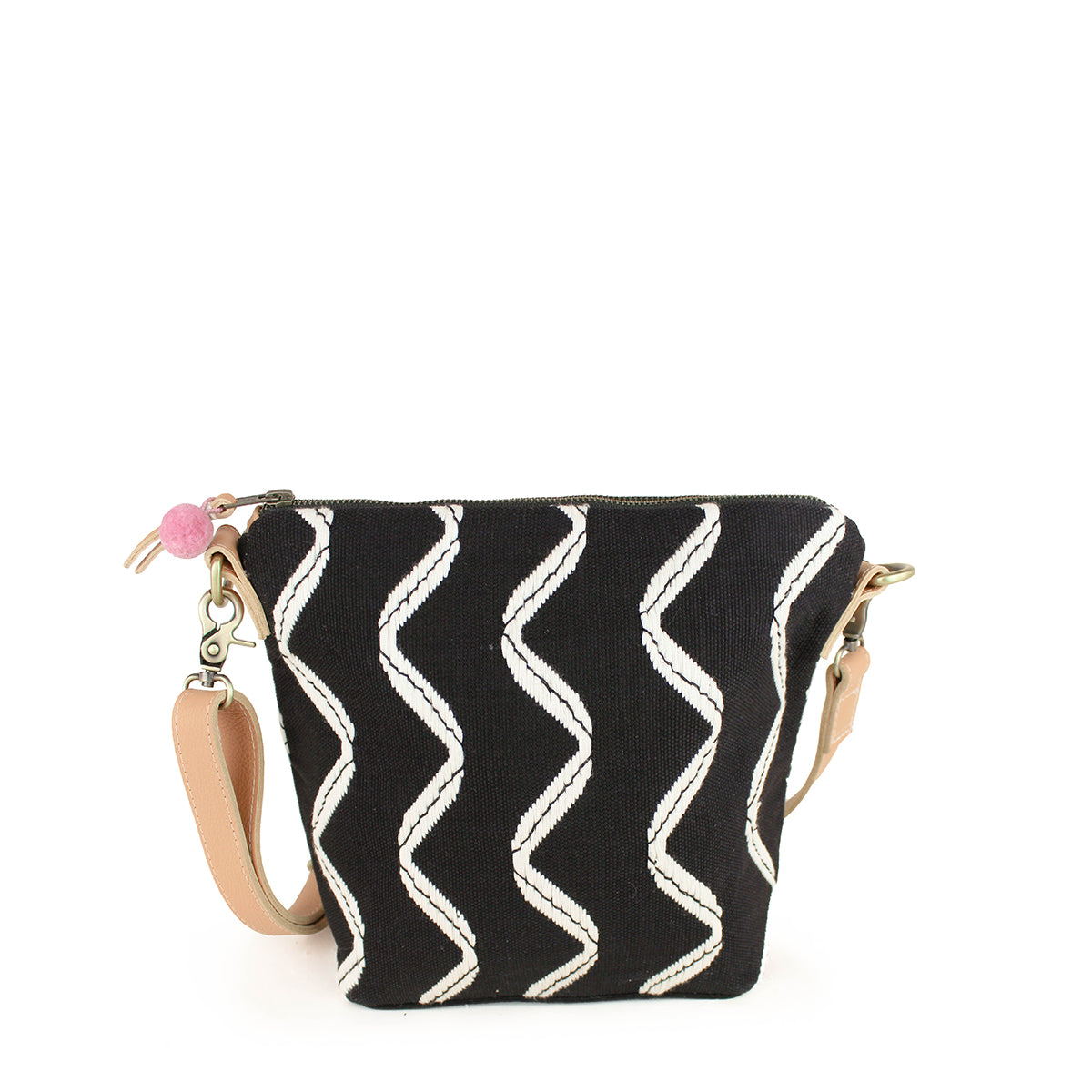 Artisan Mini Lidia Handwoven Black Sand Hobo. The Mini Lidia has vertical wavy white stripes over a black background. It has a light pink pompom and a leather detachable strap.