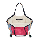 A top view of the hand woven artisan Rosa Tote in Raspberry. The interior has beige lining and a pocket.