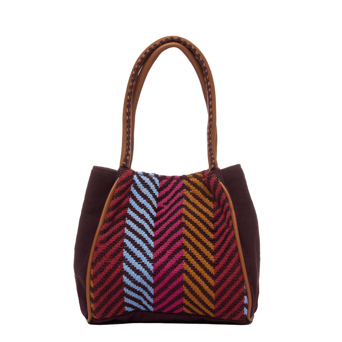 Hand woven artisan Flora Petite Tote in Chestnut shown at the back. The sides of the bag are in solid brown colors. The leather handles have brown embroidered detailing. The Winter Berry pattern has vertical yellow ochre, red, and blue stripes.