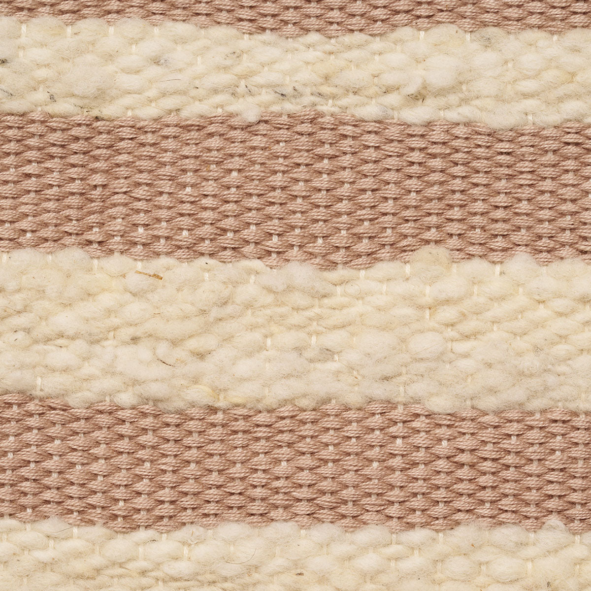 Hand woven artisan Estella Tote in Snow pattern. The photo is a close up shot of the bag. It shows the warp and weft of the fabric in pale pink and beige colors. 