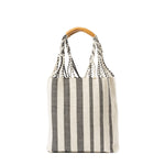 Apolonia Tote Tourmaline Basket Weave. The Apolonia has woven cords attached to leather handles. The Tourmaline pattern has vertical black and white stripes.