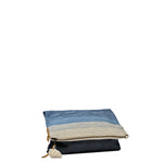 Folded side angle view of the Florentina Clutch-to-Hobo in Ocean Breeze. The pattern is a white to dark blue gradient. It has a white tassel and leather zipper pull. It is shown without the leather handle.