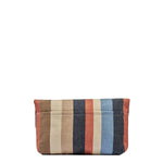 Back view of the Margarita Clutch in Blue Canyon. It has vertical orange, navy blue, light blue, beige, and tan stripes. It has an exterior pocket. 