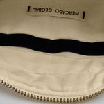 Interior view of the Felipa Belt Bag in Ocean Breeze. It has a beige lining with a dark blue hem for the pocket.