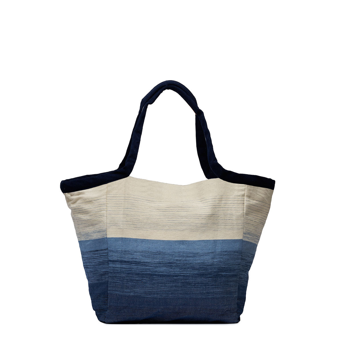 Back view of the Rosa Tote in Ocean Breeze. It has a two-toned fabric, white at the top and blue at the bottom. It has dark fabric handles with leather detailing.