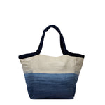 Back view of the Rosa Tote in Ocean Breeze. It has a two-toned fabric, white at the top and blue at the bottom. It has dark fabric handles with leather detailing.