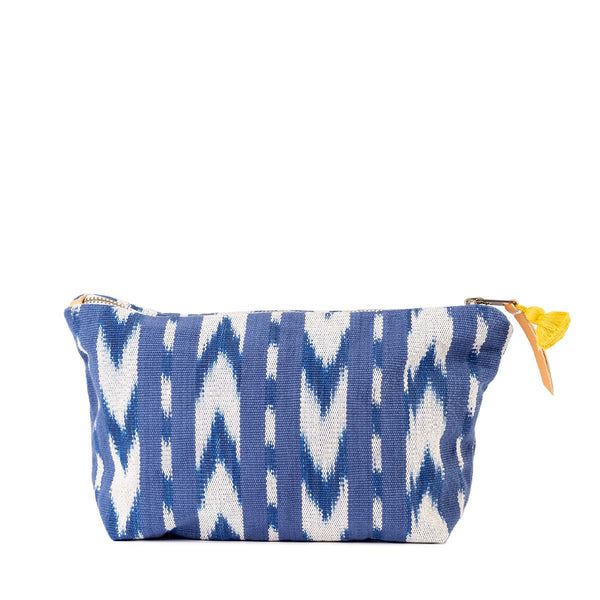 Front of the Cristina Handwoven Cosmetic Pouch in Atitlan Hills pattern. It has vertical and chevron dark blue and white stripes. It has a mini yellow tassel and a leather zipper pull.