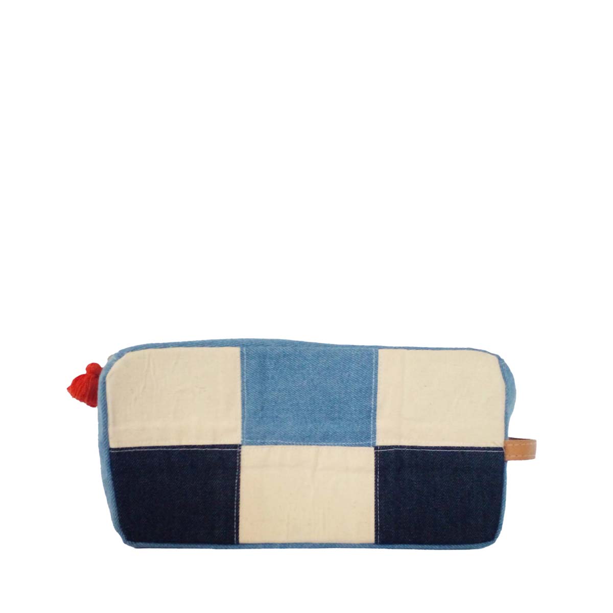 The front of the hand woven artisan Edna Dopp Kit in 90s Denim. It has a flat short rectangular shape. The pattern has a light and dark wash denim checkerboard squares. It has a red mini tassel and a leather handle on the side. 