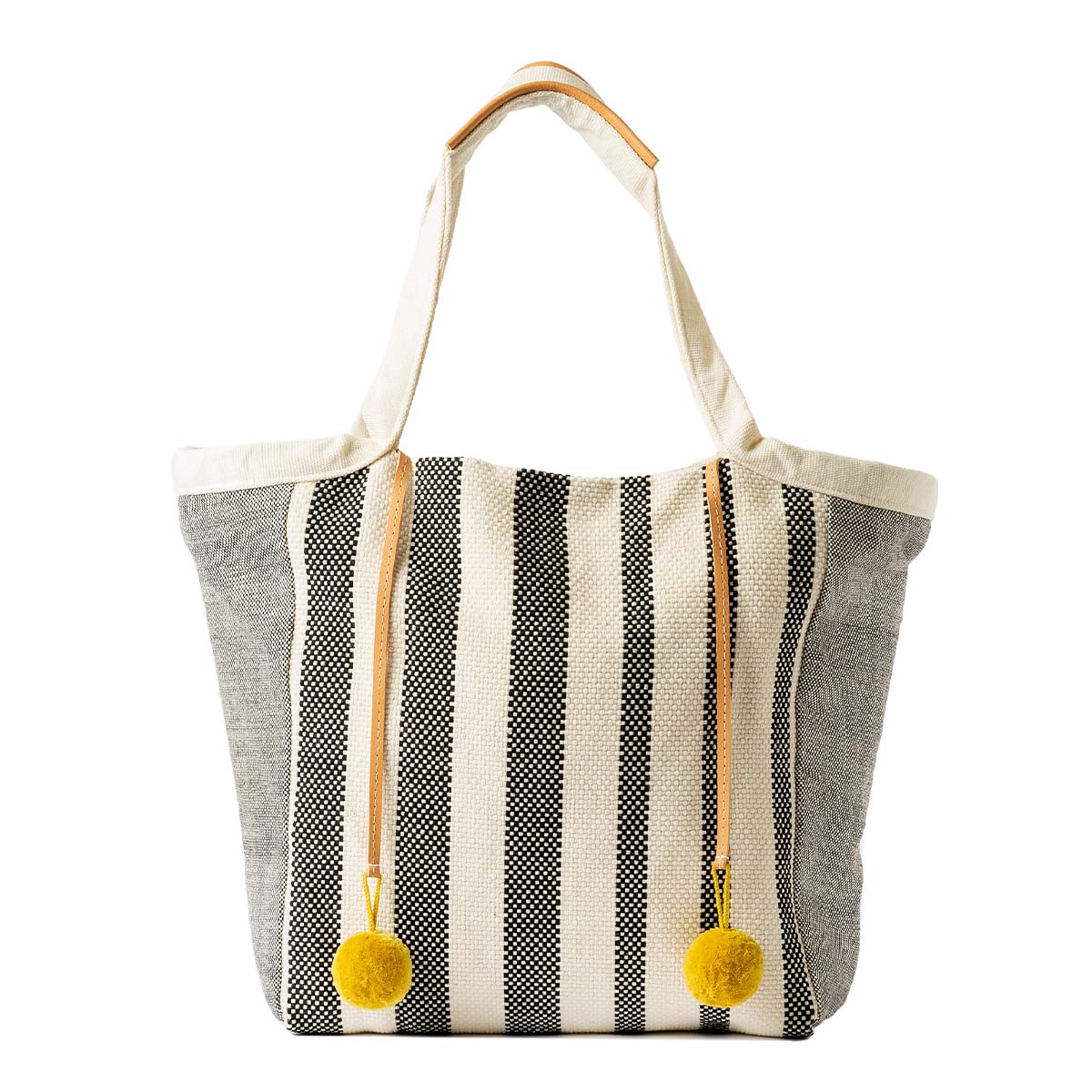The front of the hand woven artisan Rosa Tote in Tourmaline pattern. It has vertical grey and white stripes. It has yellow pompoms attached to leather cords. It has light grey lining.