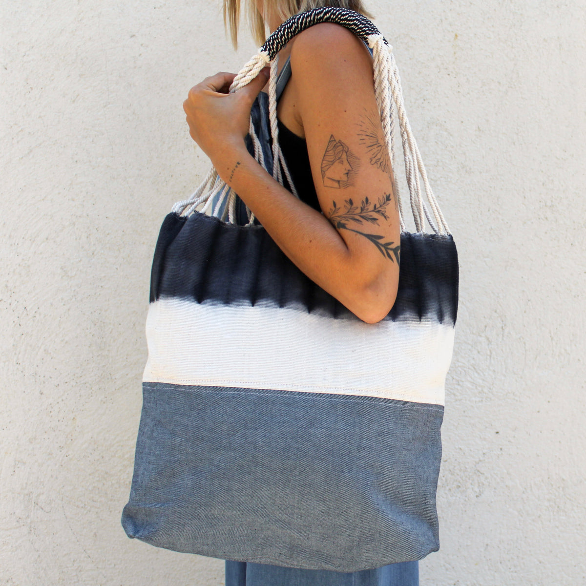 Cropped photo of model wearing Apolonia Upcycled Denim Tote in Dip-Dye.