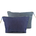 Cristina Cosmetic Pouches in dark wash denim and lighter wash denim.